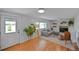 Cozy living room featuring hardwood floors, a fireplace, and natural light at 6987 E Wyoming Pl, Denver, CO 80224