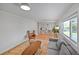 Bright living room with hardwood floors, ample seating, and a large window at 6987 E Wyoming Pl, Denver, CO 80224