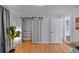 Well-lit office space with sliding closet doors, hardwood floors and neutral walls at 6987 E Wyoming Pl, Denver, CO 80224