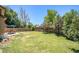 Spacious backyard with a large lawn, a fenced perimeter, and outdoor seating beneath a shaded umbrella at 5310 E Manchester Dr, Castle Rock, CO 80104