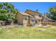 Expansive backyard featuring a well-maintained lawn, concrete patio, and manicured garden beds at 5310 E Manchester Dr, Castle Rock, CO 80104