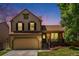 Charming two-story home with a welcoming front porch and attached two-car garage at 5310 E Manchester Dr, Castle Rock, CO 80104