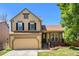 Traditional two-story home with an attached two-car garage and cozy front porch at 5310 E Manchester Dr, Castle Rock, CO 80104