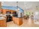 Open kitchen featuring a center island, modern appliances, and adjacent dining area at 5310 E Manchester Dr, Castle Rock, CO 80104