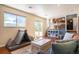 Bright and airy living room featuring hardwood floors, and large windows with backyard views at 5310 E Manchester Dr, Castle Rock, CO 80104