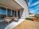 A modern outdoor patio, showcasing sliding glass doors and a manicured backyard at 21935 E 51St Dr, Aurora, CO 80019