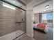 Modern bathroom with a glass-enclosed shower and stylish tile work, adjoining the spacious main bedroom at 21935 E 51St Dr, Aurora, CO 80019