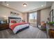 Spacious main bedroom featuring a tray ceiling, large window with natural light, and a cozy sitting area at 21935 E 51St Dr, Aurora, CO 80019