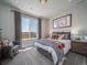 Bright bedroom featuring a large window, comfortable furniture, and stylish decor at 21935 E 51St Dr, Aurora, CO 80019