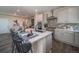 Kitchen with island, quartz counters, stainless appliances, and attached dining area at 21935 E 51St Dr, Aurora, CO 80019