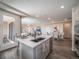 Kitchen island with stainless steel sink, dining area and access to outdoor balcony at 21935 E 51St Dr, Aurora, CO 80019