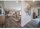 Open-concept living room with hardwood floors, modern decor, and seamless flow to the kitchen and dining area at 21935 E 51St Dr, Aurora, CO 80019