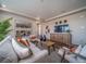 Bright living room featuring a modern sofa, hardwood floors, and decorative mirrors at 21935 E 51St Dr, Aurora, CO 80019