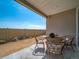 Comfortable covered patio showcases a charming table set, ideal for outdoor relaxation at 21935 E 51St Dr, Aurora, CO 80019