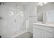 Modern bathroom featuring a glass-enclosed shower, sleek fixtures, and a white vanity with ample storage at 453 Interlocken Blvd # 104, Broomfield, CO 80021