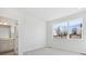 Neutral bedroom featuring a large window with neighborhood views and an ensuite bathroom at 453 Interlocken Blvd # 104, Broomfield, CO 80021
