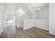 Bright hallway with hardwood floors leading to a staircase and open living space, all in a neutral color palette at 453 Interlocken Blvd # 104, Broomfield, CO 80021