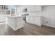 Modern kitchen featuring white cabinets, a center island with a sink, and stainless steel appliances, perfect for cooking at 453 Interlocken Blvd # 104, Broomfield, CO 80021