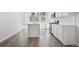 Modern kitchen with island, gas range, white cabinetry, and wood floors at 453 Interlocken Blvd # 104, Broomfield, CO 80021