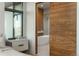 Bright bathroom features a freestanding tub and a sliding wood door for added privacy at 651 Emberglow Ln, Highlands Ranch, CO 80126