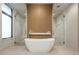 Bright bathroom features a soaking tub between two glass-enclosed showers and modern fixtures at 651 Emberglow Ln, Highlands Ranch, CO 80126