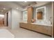 Spacious bathroom features dual sinks with lighted mirrors and contemporary fixtures at 651 Emberglow Ln, Highlands Ranch, CO 80126