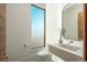 Chic powder room features a unique sink, minimalist design, and a bright window for natural light at 651 Emberglow Ln, Highlands Ranch, CO 80126