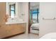 An elegant bathroom showcasing a marble countertop, wood vanity, and a glimpse into the serene bedroom at 651 Emberglow Ln, Highlands Ranch, CO 80126