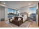A sunlit bedroom offers a tranquil retreat with its comfortable seating area and scenic outdoor views at 651 Emberglow Ln, Highlands Ranch, CO 80126