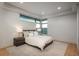 Bright bedroom features a large bed with nightstands and views from the large windows at 651 Emberglow Ln, Highlands Ranch, CO 80126
