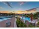 Community pool area showcasing multiple pools, lounge chairs, and lush landscaping under a vibrant sunset at 651 Emberglow Ln, Highlands Ranch, CO 80126