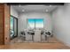 Dining room features modern lighting, stone design elements and a window with stunning scenic views at 651 Emberglow Ln, Highlands Ranch, CO 80126
