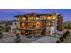 Modern home featuring multi-level balconies and a meticulously landscaped yard, captured at dusk at 651 Emberglow Ln, Highlands Ranch, CO 80126