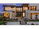 Elegant modern home featuring a manicured lawn and striking architectural details at 651 Emberglow Ln, Highlands Ranch, CO 80126