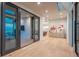 Bright foyer with light wood floors, modern art, and glass doors to outdoor patio at 651 Emberglow Ln, Highlands Ranch, CO 80126