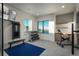 Well-lit home gym with exercise equipment, natural light, and views of the surrounding landscape at 651 Emberglow Ln, Highlands Ranch, CO 80126