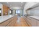 Contemporary kitchen with a marble island, stainless appliances, and open dining area at 651 Emberglow Ln, Highlands Ranch, CO 80126
