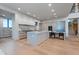Modern kitchen with waterfall island, stainless appliances, and hardwood floors at 651 Emberglow Ln, Highlands Ranch, CO 80126