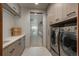 Spacious laundry room with washer, dryer, counterspace, and ample cabinet storage at 651 Emberglow Ln, Highlands Ranch, CO 80126