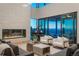 Bright living room with piano, fireplace, and expansive windows offering panoramic views at 651 Emberglow Ln, Highlands Ranch, CO 80126