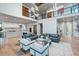Expansive living room with open kitchen, piano, fireplace, and stylish contemporary decor at 651 Emberglow Ln, Highlands Ranch, CO 80126