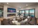 Spacious living room featuring a fireplace, and expansive glass doors with stunning mountain views at 651 Emberglow Ln, Highlands Ranch, CO 80126