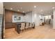 Bright living room with hardwood floors, built-in cabinets, a stone countertop bar and staircase access at 651 Emberglow Ln, Highlands Ranch, CO 80126
