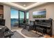 Comfortable living room has grand piano and glass slider to patio with scenic views at 651 Emberglow Ln, Highlands Ranch, CO 80126