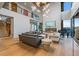 Spacious living room with a fireplace, piano, and soaring ceilings creating an airy ambiance at 651 Emberglow Ln, Highlands Ranch, CO 80126