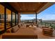 Spacious covered patio with lounge seating and stunning views at 651 Emberglow Ln, Highlands Ranch, CO 80126