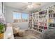 Cozy bedroom with built-in bookshelf and window seat at 20572 E Girard Dr, Aurora, CO 80013