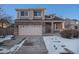 Two-story brick home with attached garage and snowy front yard at 20572 E Girard Dr, Aurora, CO 80013