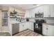 Modern kitchen featuring white cabinets, granite countertops, and stainless steel appliances at 20572 E Girard Dr, Aurora, CO 80013