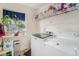 Convenient laundry room with washer, dryer, and shelving at 20572 E Girard Dr, Aurora, CO 80013